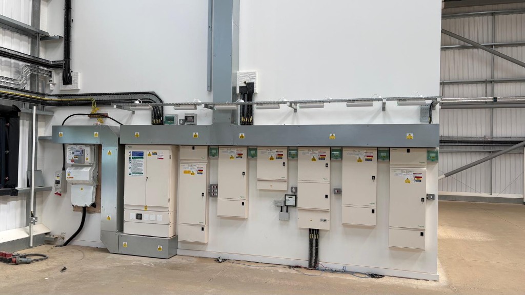 Loades Unit F — LV distribution boards and trunking on a finished industrial wall